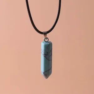Detail of a blue hexagonal column stone pendant with black leather cord necklace