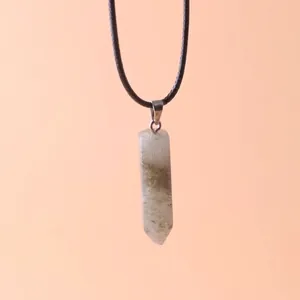 Macro view of a hexagonal prism crystal stone pendant with natural quartz texture