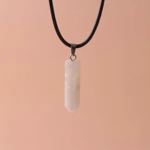 Macro detail of a hexagonal white quartz pillar pendant with a smooth polished finish.