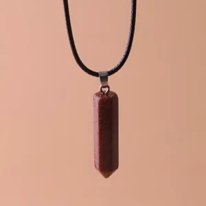 Close-up of hexagonal brown goldstone pillar pendant necklace with black cord