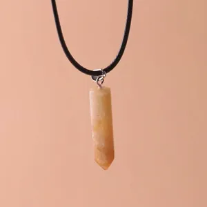 Close-up of hexagonal pillar quartz crystal pendant on a black cord necklace