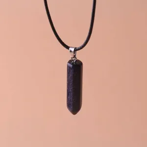 Detail of hexagonal blue goldstone bullet pendant necklace with black cord