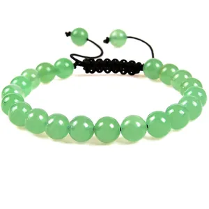 Close-up detail van 8 mm groene edelsteen kralen op een zwart gevlochten armband.
