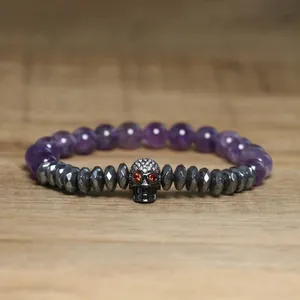Detailed view of gothic skull beaded bracelet with hematite and purple stones