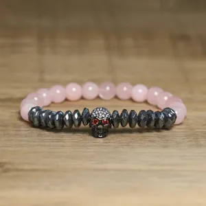Detailed view of gothic skull bracelet with pink beads and faceted hematite