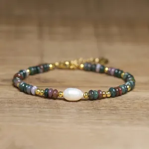 Macro detail of exquisite handmade bracelet with natural stones and central baroque pearl