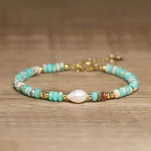 Detailed view of a handmade baroque pearl and turquoise stone beaded bracelet for women.
