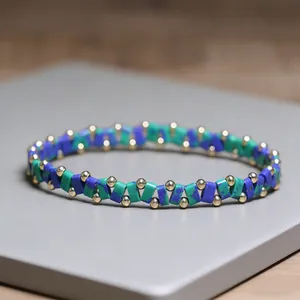 Detailed macro view of geometric blue and turquoise stone beads with small gold accents