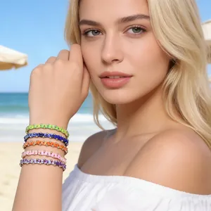 Close-up of colorful handmade beaded elastic bracelets worn by a model at the beach