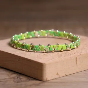 Detailed view of handcrafted green stone beaded bracelet on rustic wooden display