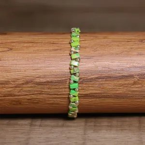 Handmade green stone beaded elastic bracelet with small silver metallic accents
