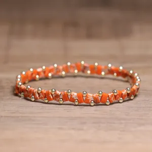 Handmade orange stone beaded bracelet with small gold spacer beads for men and women