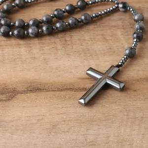 Detailed close-up of natural labradorite beads necklace with a metallic hematite cross pendant