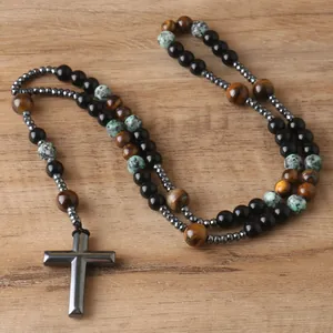 Detailed view of hematite cross pendant with tiger eye and natural stone beads