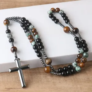 Close-up of hematite cross pendant with tiger's eye and speckled stone prayer beads