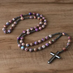 Close-up view of a natural stone bead rosary necklace with a hematite cross pendant