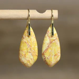 Detailed view of yellow natural imperial stone teardrop earrings with elegant gold hooks