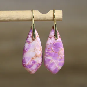 Close-up of teardrop purple Emperor stone earrings with unique natural patterns.