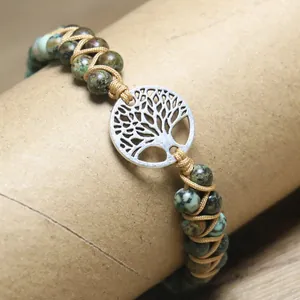 Detailed view of handmade African Turquoise beaded wrap bracelet with Tree of Life charm.