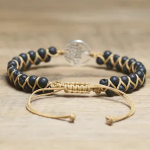Detailed view of handmade woven Tree of Life bracelet with adjustable cord and lava beads