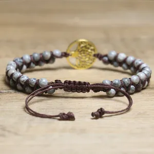 Macro detail of hand-woven brown cord and grey African pine stone beads bracelet