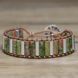 Detailed macro view of unakite stone beads and woven leather on a handmade bracelet
