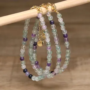 Detail view of handmade natural green aventurine and white turquoise beaded necklaces