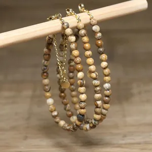 Detailed close-up showing natural stone beads and gold-plated adjustable extender chain.