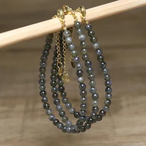 Close-up of handmade natural stone beaded necklaces with gold-tone stainless steel clasps.