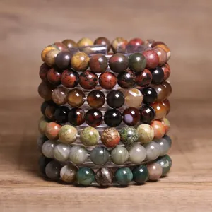 Macro detail of 8mm natural Indian agate stone beaded bracelets stacked on display