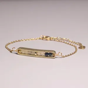Close-up of gold-plated bar bracelet featuring natural crystal and hematite beads