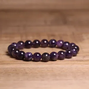 Macro detail showing texture and deep purple luster of 8mm amethyst stone bracelet