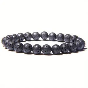 Macro detail shot of natural black lava stone beaded bracelet with porous texture