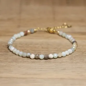 Close-up of faceted natural African turquoise stone beads on an adjustable jewelry piece.