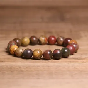 Detailed view of 8mm natural Indian agate beaded bracelet on rustic wooden surface.