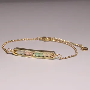 Detail view of gold plated bracelet with multi-colored stone beads bar