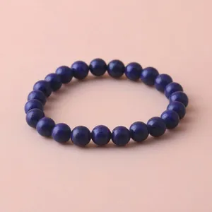 Close-up view of an 8mm deep blue healing stone beaded stretch bracelet for women