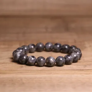Detailed macro view of 8mm natural grey stone beads on a stretch bracelet with unique patterns