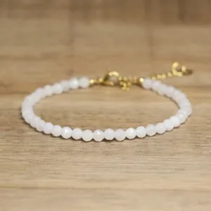 Detailed macro view of white faceted stone beads on a delicate adjustable bracelet