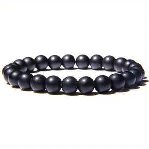 Close-up detail of an 8mm matte black healing stone beaded bracelet with elastic cord