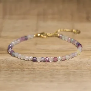 Close-up of faceted natural stone beaded bracelet with adjustable gold chain