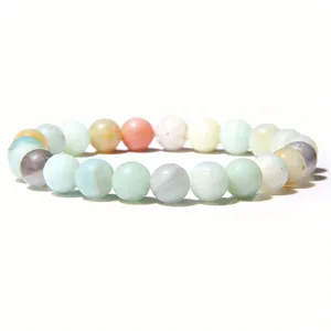 Detailed macro view of 8mm healing stone beaded elastic bracelet in pastel colors