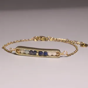 Macro view of dainty gold-plated bracelet featuring lapis lazuli and mixed stone beads