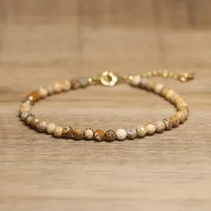 Detail view of handmade faceted African jasper beaded bracelet with gold chain.