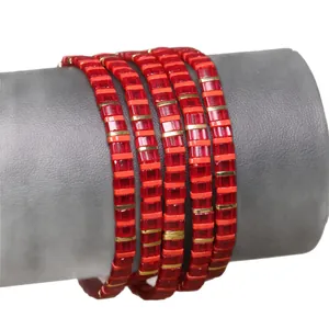 Handmade red Tila bead bracelet featuring metallic gold spacers in a stylish layered design
