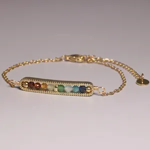 Detailed view of a minimalist gold-plated bracelet featuring multi-colored natural gemstone beads