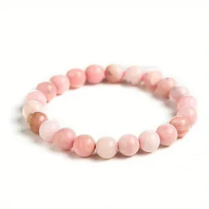 Detailed macro view of 8mm pink natural stone beads on a healing crystal bracelet