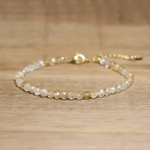 Detailed view of faceted natural stone beads and gold-tone lobster clasp on bracelet