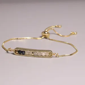 Detail of gold plated slider bracelet with multi-color natural stone beads