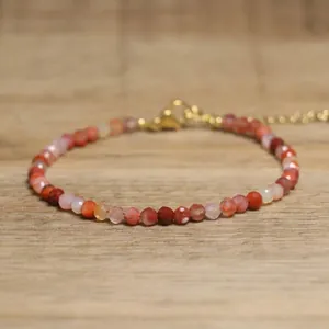 Close-up of handmade faceted natural stone beaded bracelet with adjustable gold clasp